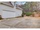 Two car garage with a large concrete driveway at 3640 Rolling Creek Dr, Buford, GA 30519