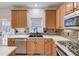 Kitchen features light wood cabinets, a double sink, and stylish backsplash at 3640 Rolling Creek Dr, Buford, GA 30519