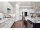 Modern kitchen featuring white cabinets, granite countertops, and a farmhouse sink at 4983 Kyle Dr, Powder Springs, GA 30127