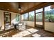 Relaxing screened porch with stone patio and ceiling fan at 4983 Kyle Dr, Powder Springs, GA 30127