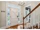 Bright entryway with hardwood floors, white door, and staircase at 975 Seaboard Nw Ave, Atlanta, GA 30318