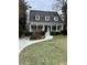 Two-story house with white exterior, front porch, and landscaped lawn at 975 Seaboard Nw Ave, Atlanta, GA 30318