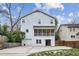 White two-story home with screened porch and detached garage at 975 Seaboard Nw Ave, Atlanta, GA 30318