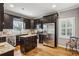 Modern kitchen with dark cabinets, stainless steel appliances, and island at 975 Seaboard Nw Ave, Atlanta, GA 30318