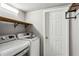 Laundry room with washer, dryer, and built-in shelving at 975 Seaboard Nw Ave, Atlanta, GA 30318