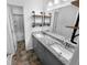 Updated bathroom with double vanity, granite countertop and decorative tile flooring at 6049 Shallow Wood Ct, Douglasville, GA 30135