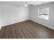 Bright bedroom with hardwood floors and a window with blinds at 6049 Shallow Wood Ct, Douglasville, GA 30135
