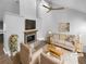 Virtually staged living room with fireplace and hardwood floors at 6049 Shallow Wood Ct, Douglasville, GA 30135