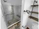 Walk-in shower with pebble tile flooring and glass enclosure at 6049 Shallow Wood Ct, Douglasville, GA 30135