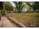 Landscaped backyard with stone retaining wall at 1098 Jefferson Ave, East Point, GA 30344