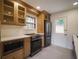 Modern kitchen with stainless steel appliances and light oak cabinets at 1098 Jefferson Ave, East Point, GA 30344