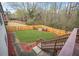 Landscaped backyard with wooden deck and steps at 127 Ennisbrook Se Dr, Smyrna, GA 30082