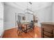 Formal dining room with hardwood floors, chandelier, and access to kitchen at 127 Ennisbrook Se Dr, Smyrna, GA 30082