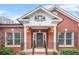 Brick front entry with columns, decorative accent, and dark gray door at 127 Ennisbrook Se Dr, Smyrna, GA 30082