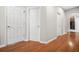 Hardwood floors and neutral walls in a spacious hallway at 127 Ennisbrook Se Dr, Smyrna, GA 30082