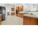 Kitchen with oak cabinets, black appliances, and tile flooring at 127 Ennisbrook Se Dr, Smyrna, GA 30082