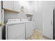 Bright laundry room with washer, dryer, and ample cabinets at 127 Ennisbrook Se Dr, Smyrna, GA 30082