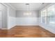 Dining room with hardwood floors, wainscoting, and chandelier at 230 Ascott Ln, Woodstock, GA 30189