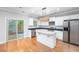 Kitchen with white cabinets, granite counters, and island at 230 Ascott Ln, Woodstock, GA 30189