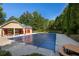 Community pool with a safety cover, picnic tables, and nearby restrooms at 230 Ascott Ln, Woodstock, GA 30189