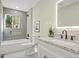 Updated bathroom featuring a bathtub, gray tile, and granite countertop at 2716 Riggs Dr, East Point, GA 30344