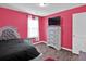 Bright bedroom with gray upholstered bed, dresser, and pink walls at 2805 Ellis Pointe Ave, Conyers, GA 30094