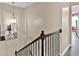 Modern staircase with dark metal railing and light walls at 2805 Ellis Pointe Ave, Conyers, GA 30094