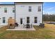 White two-story house with patio furniture on grass backyard with privacy fence at 8218 Tiger Way, Riverdale, GA 30296