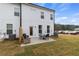 Backyard view of townhome featuring patio with outdoor furniture and grassy area at 8218 Tiger Way, Riverdale, GA 30296