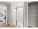 Modern bathroom showing a glass-enclosed shower and a closet with wire shelving at 8218 Tiger Way, Riverdale, GA 30296