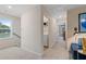 Upstairs hallway with laundry room, linen closet, and a bright window at 8218 Tiger Way, Riverdale, GA 30296