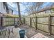 Small fenced patio with seating area, planters, and a shade sail at 1803 Ashborough Way # Apt F, Marietta, GA 30067