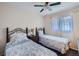 Bedroom with two twin beds, nightstand, and ceiling fan at 1803 Ashborough Way # Apt F, Marietta, GA 30067