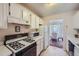 Kitchen features white cabinets, microwave, and stove at 1803 Ashborough Way # Apt F, Marietta, GA 30067