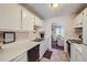 White kitchen cabinets, gas stove, and dishwasher at 1803 Ashborough Way # Apt F, Marietta, GA 30067