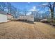 Backyard view of this beautiful home, showing the freshly cut lawn and a detached storage shed at 2480 Melody Nw Ln, Kennesaw, GA 30152