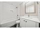 Bathroom featuring a tub with shower, tiled walls, and a modern vanity sink at 2480 Melody Nw Ln, Kennesaw, GA 30152