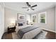 Modern bedroom featuring ceiling fan, hardwood floors, and light gray walls at 2480 Melody Nw Ln, Kennesaw, GA 30152