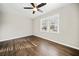 This bedroom has hardwood floors, a ceiling fan, and two large windows at 2480 Melody Nw Ln, Kennesaw, GA 30152