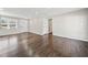 Spacious living room showing hardwood floors, neutral paint, and a door leading to other rooms at 2480 Melody Nw Ln, Kennesaw, GA 30152