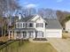 Two-story house featuring a white exterior, gray roof, and a spacious front porch at 4324 Crofton Overlook, Suwanee, GA 30024