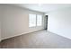 Bright bedroom features a large window, neutral carpet, and fresh, white paint at 5342 Legacy Trl, Douglasville, GA 30135