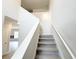 Carpeted staircase with white banister and neutral walls leads to the upper level at 5342 Legacy Trl, Douglasville, GA 30135