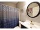 A bathroom featuring a toilet, sink, a decorative mirror, and a shower curtain at 123 Hollow Springs Dr, Hiram, GA 30141