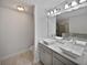 Double vanity bathroom with a large mirror and soaking tub at 1710 Garbrooke Cv, Lawrenceville, GA 30046