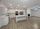 Modern kitchen with white cabinets, island, and stainless steel appliances at 1710 Garbrooke Cv, Lawrenceville, GA 30046