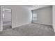 Simple bedroom with gray carpet and an adjacent bathroom at 204 Hickory Commons Way, Canton, GA 30115