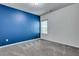 Bright bedroom with gray carpet and blue accent wall at 204 Hickory Commons Way, Canton, GA 30115