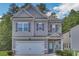 Two-story house with gray siding, stone accents, and a two-car garage at 204 Hickory Commons Way, Canton, GA 30115