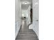 Bright hallway with gray flooring and white trim, leading to the living area and staircase at 204 Hickory Commons Way, Canton, GA 30115